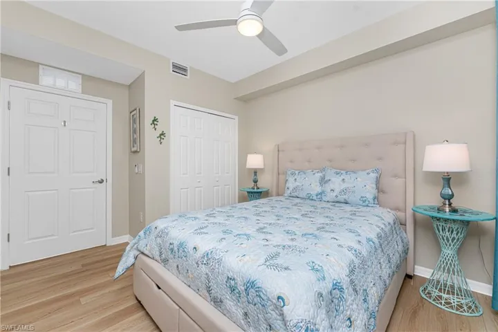 Bedroom with light wood-style flooring, ceiling fan, and a closet