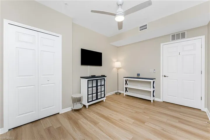 Unfurnished bedroom with light wood-style flooring, a closet, and ceiling fan