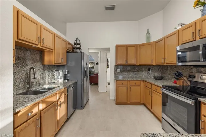 Kitchen with soft close cabinets, granite counter tops & backsplash, stainless steel appliances