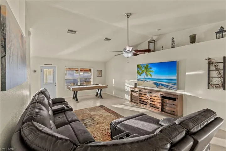 Living room with tile flooring, ceiling fan, Cathedral Ceiling