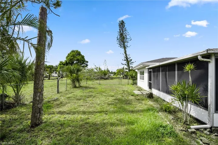 View of yard with a sunroom