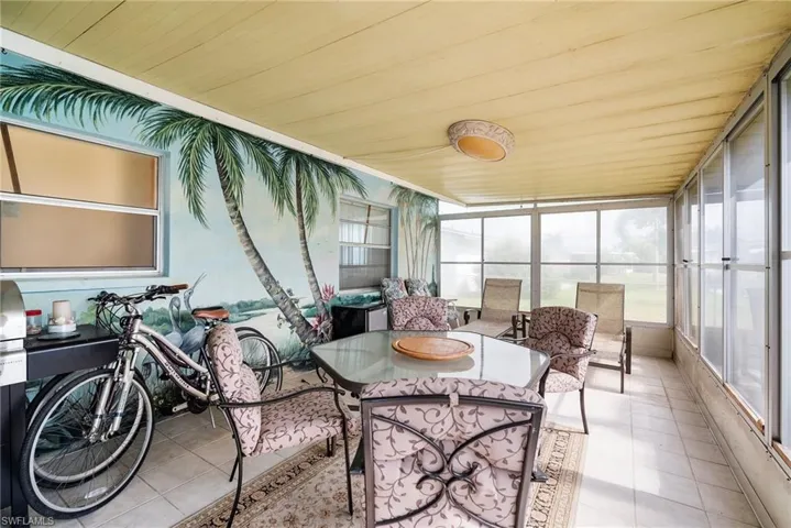 Sunroom featuring wooden ceiling