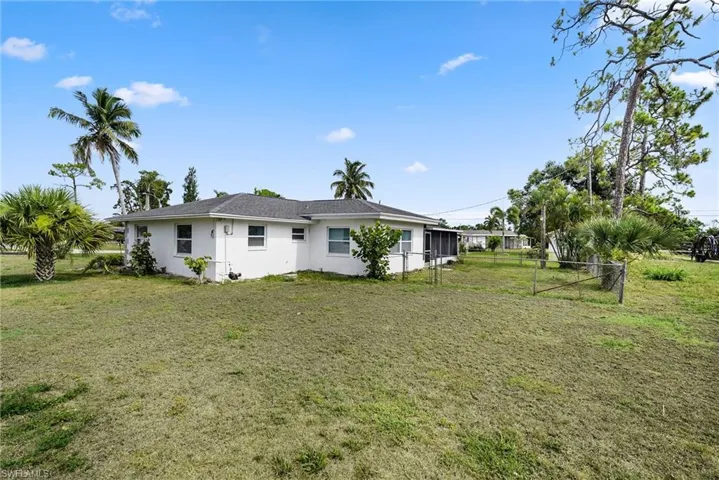 Back of house featuring a lawn