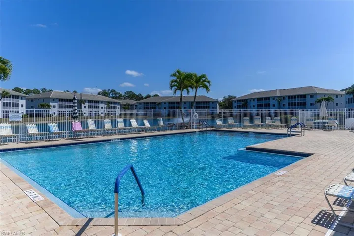 Community pool with a residential view and a patio
