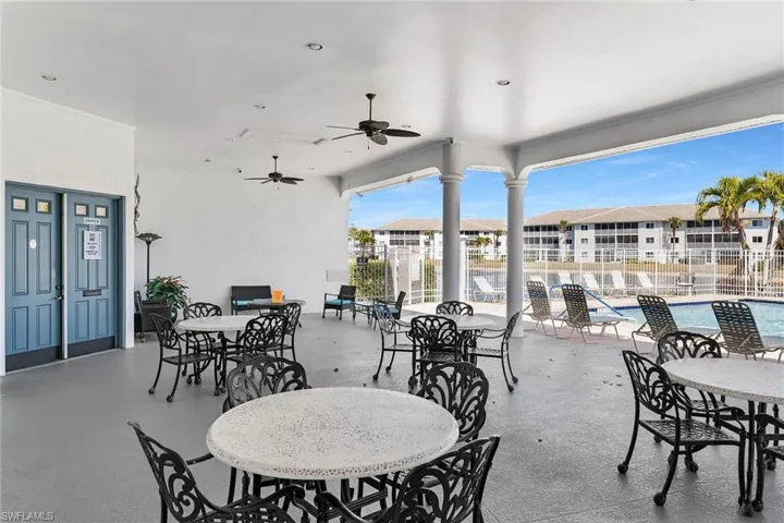 View of patio / terrace featuring outdoor dining space, a ceiling fan, and a community pool