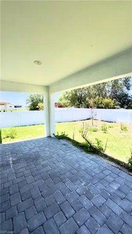 Covered patio featuring a paver surface