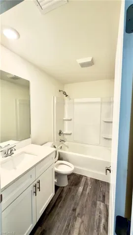 Bathroom with white vanity, integrated sink, and chrome fixtures