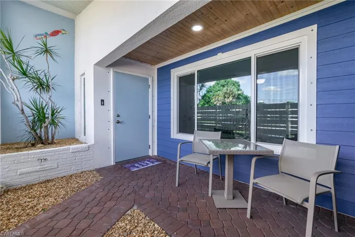 Enter the property through the covered porch upon going through front privacy gate.