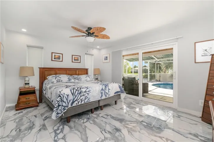 Primary bedroom opens up to lanai/pool and has ensuite bathroom.