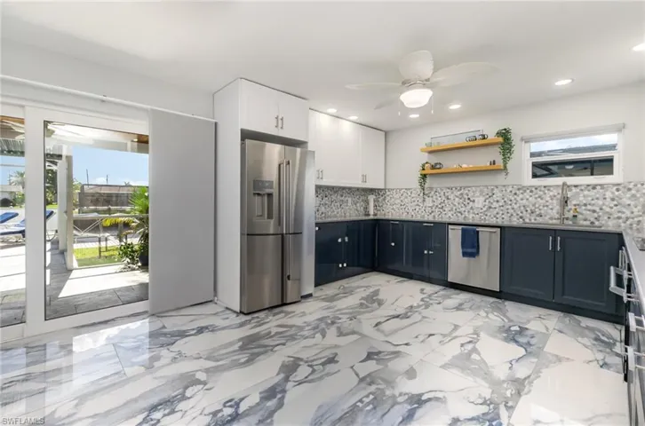 Kitchen without 'kitchen island on wheels' - use as you wish! Enjoy soft-close cabinetry and stainless steel appliances.