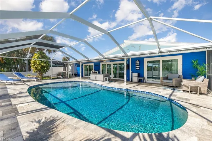Enjoy SWFL lifestyle w/large screened-in lanai, covered sitting area and saltwater pool with travertine tile pavers.