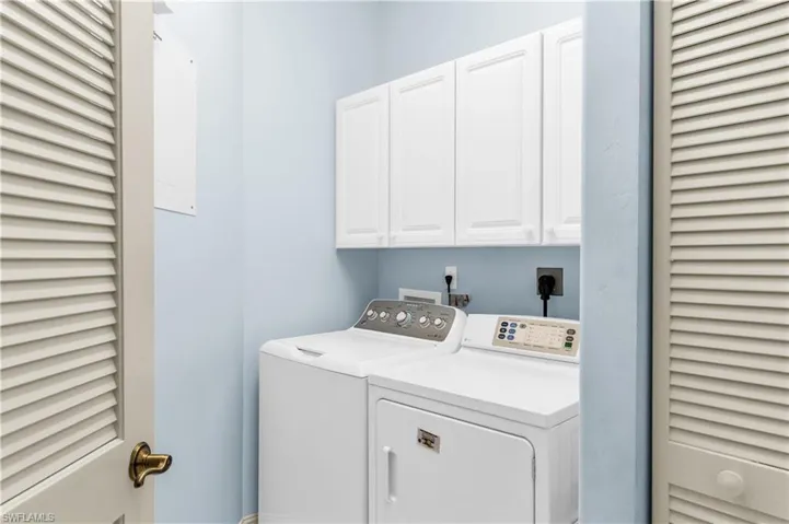 Washroom featuring cabinets and independent washer and dryer