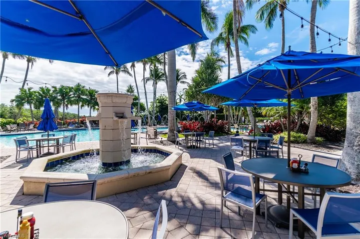 View of patio / terrace with pool water feature and a community pool