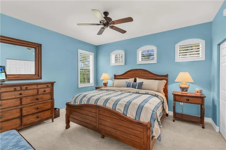 Carpeted bedroom with ceiling fan