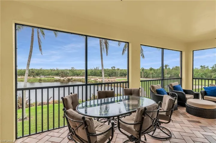 Sunroom featuring a water view