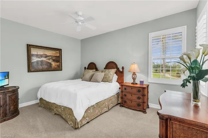 Bedroom featuring ceiling fan and carpet floors
