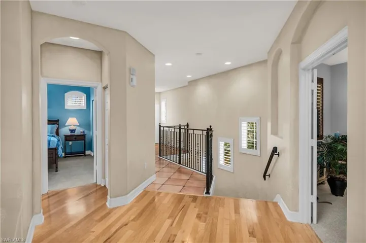 Corridor with light hardwood / wood-style flooring