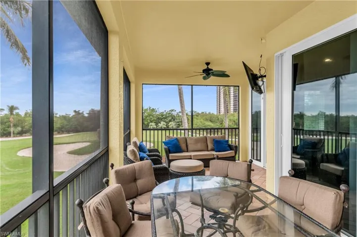 Sunroom featuring ceiling fan