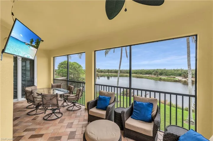 Sunroom / solarium with a water view and ceiling fan