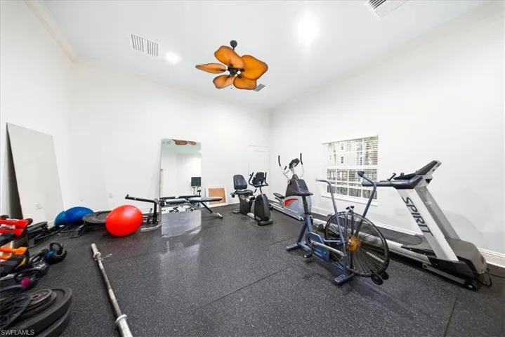Workout room featuring ornamental molding