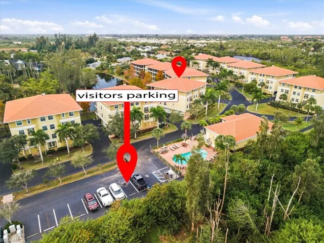 Drone / aerial view of apartment complex / building and a nearby body of water