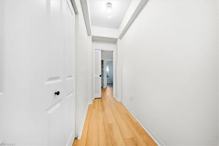 Hallway featuring baseboards and light wood-style floors