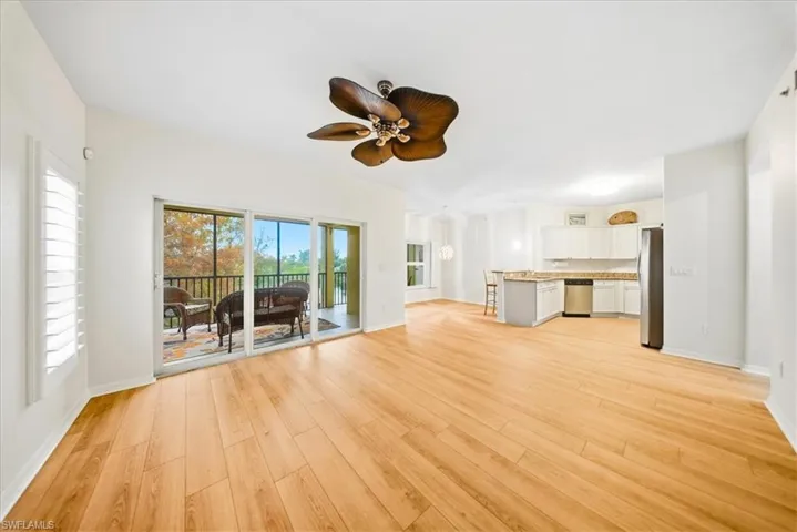 Unfurnished living room with light wood-type flooring and a ceiling fan