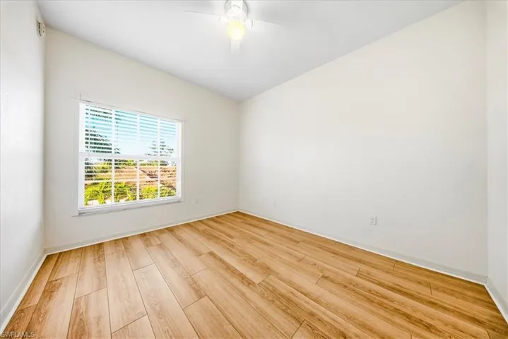 Empty room featuring light wood finished floors and baseboards