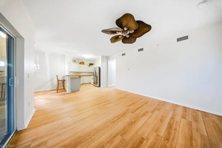 Unfurnished living room featuring light wood finished floors and ceiling fan