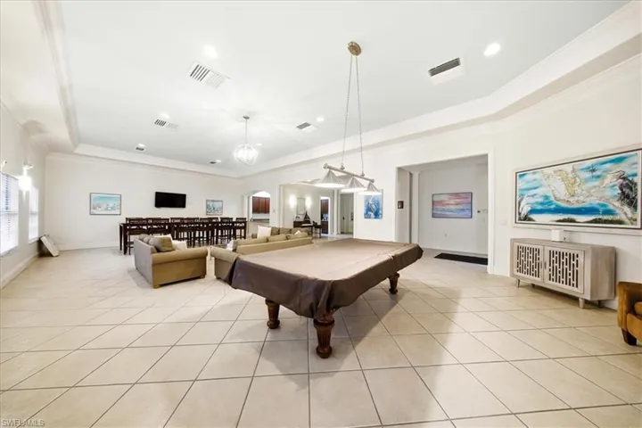 Recreation room featuring arched walkways, ornamental molding, pool table, and recessed lighting