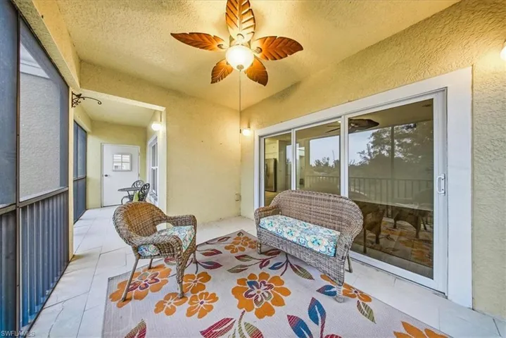 Sunroom / solarium featuring ceiling fan