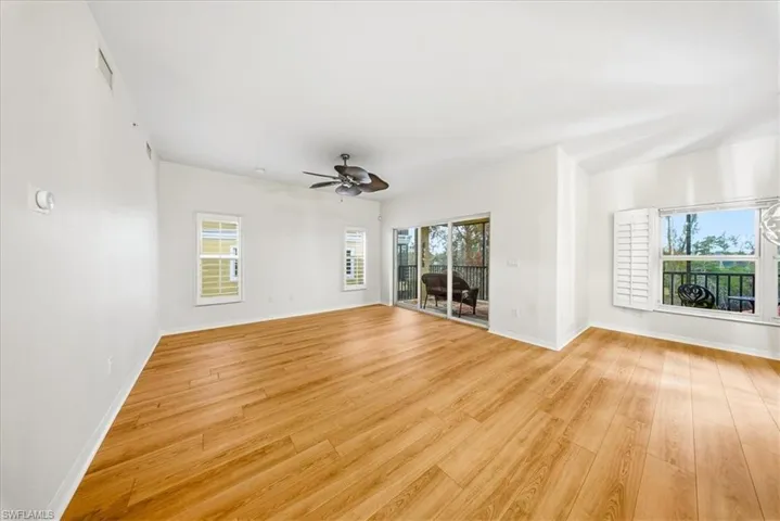Spare room with light wood-type flooring, plenty of natural light, and ceiling fan