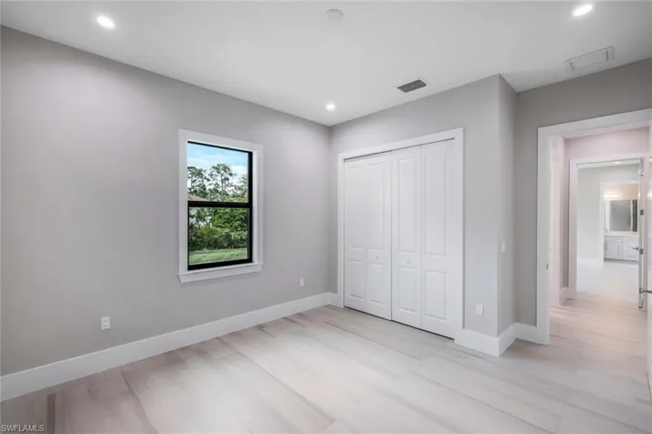 Unfurnished bedroom with a closet and light hardwood / wood-style flooring