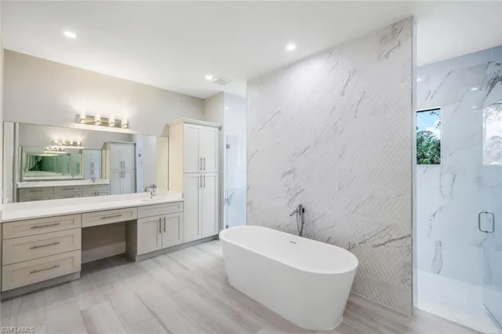 Bathroom featuring independent shower and bath and large vanity