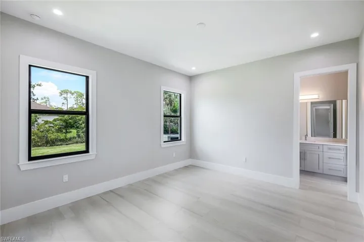 Spare room featuring sink and light wood-type flooring