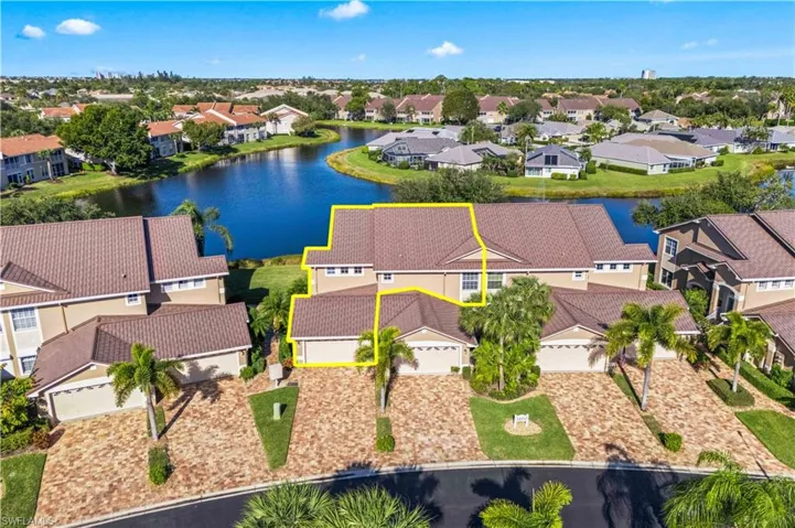 Aerial view of residential area featuring a nearby body of water
