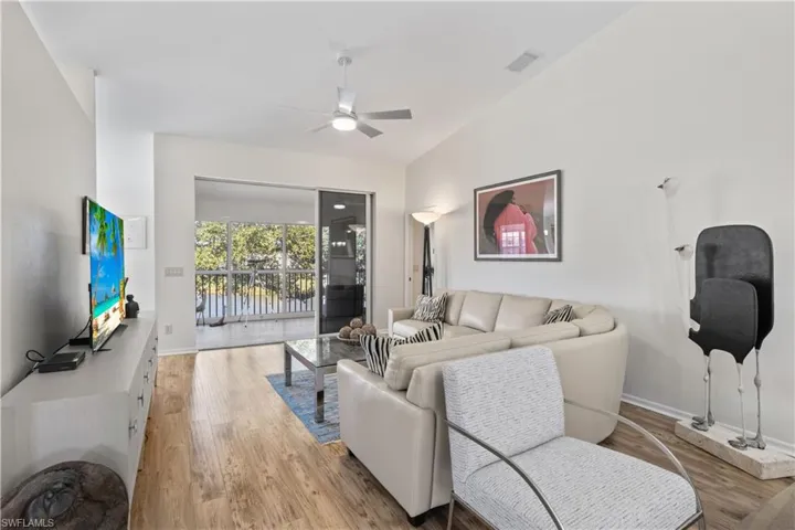 Living area with light wood-style flooring and ceiling fan