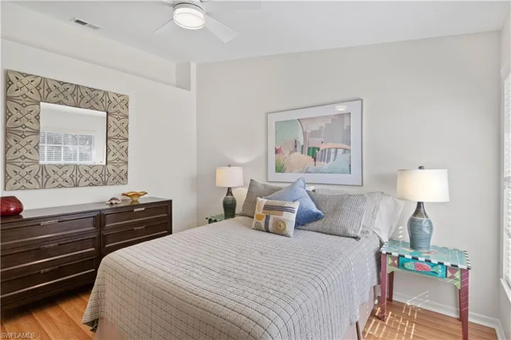 Bedroom with ceiling fan and light wood finished floors
