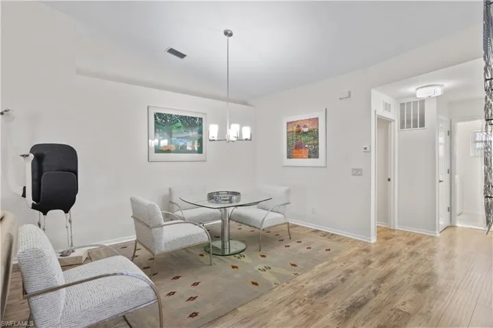 Dining area featuring a chandelier and light wood-type flooring
