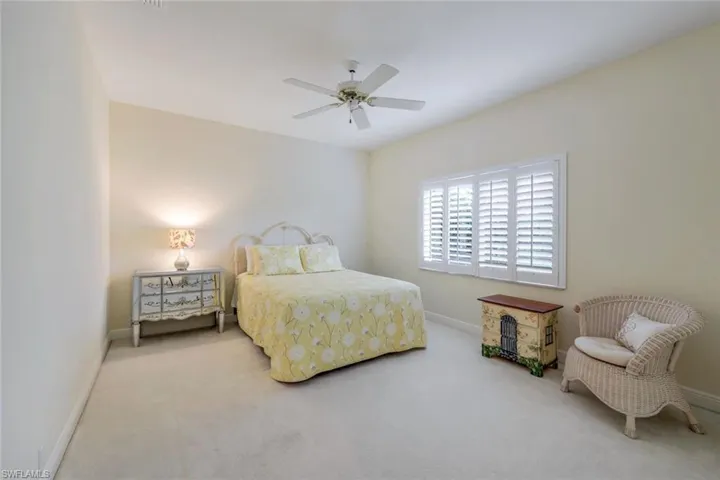 Carpeted bedroom with ceiling fan