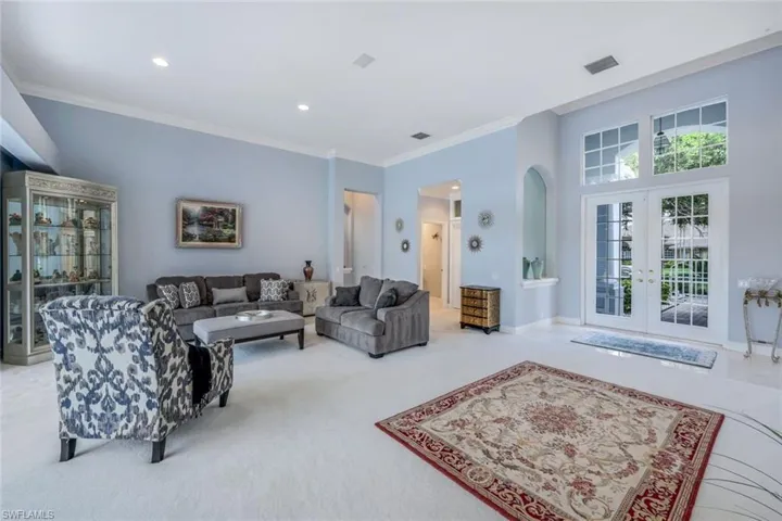 Living room featuring ornamental molding, carpet flooring, and french doors