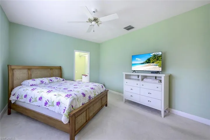 Bedroom featuring ceiling fan and light carpet