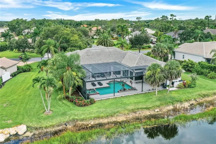 Birds eye view of property with a water view