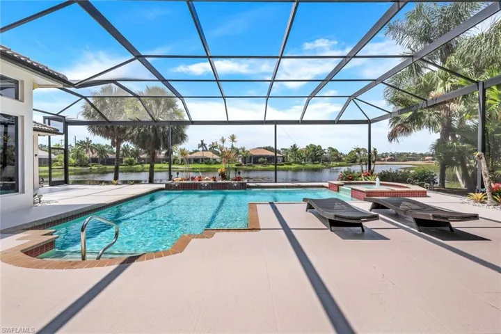 View of pool with a patio, a lanai, an in ground hot tub, and pool water feature