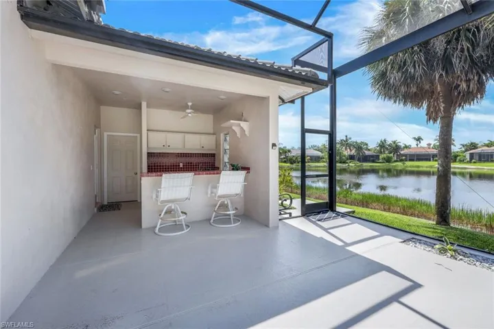 Unfurnished sunroom featuring ceiling fan and a water view
