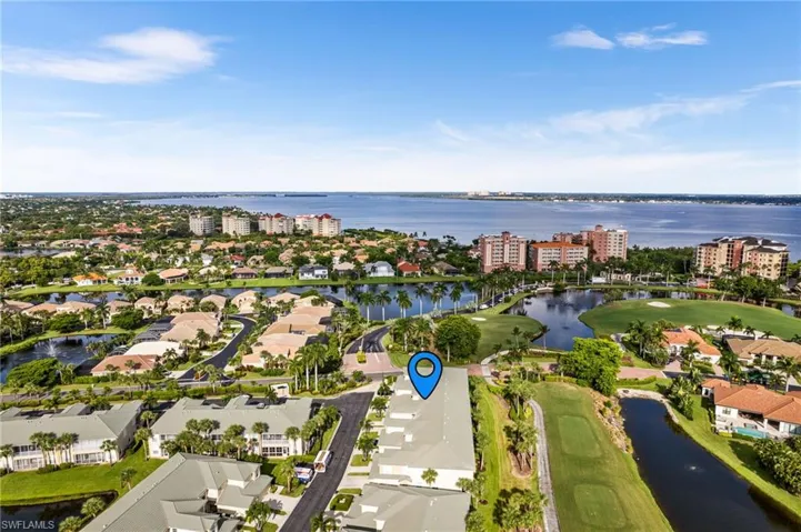 Aerial view with a water view and golf course views.