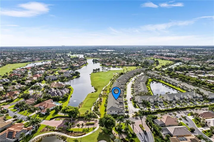 Birds eye view of property with a water view