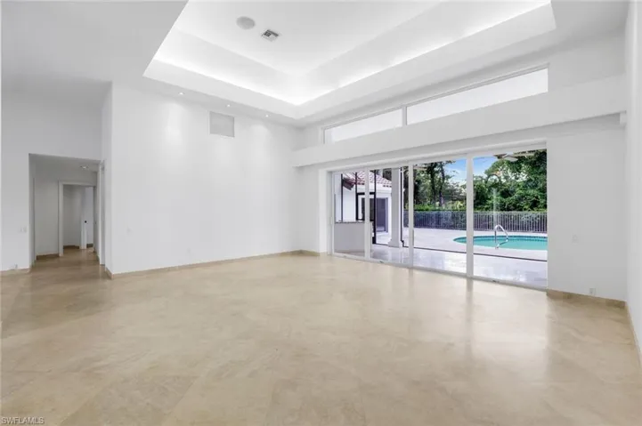 Unfurnished room with a raised ceiling and a towering ceiling