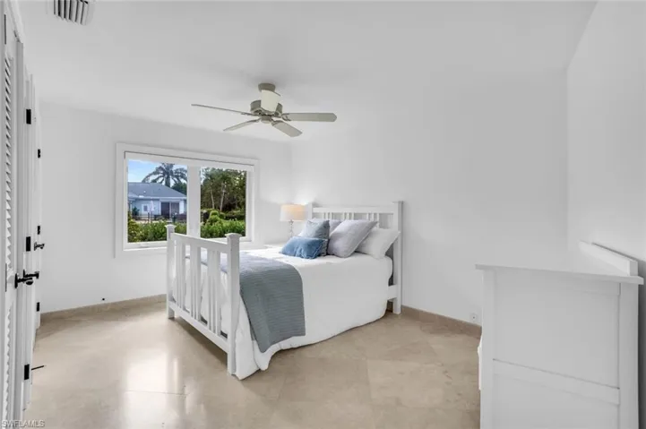 Bedroom with ceiling fan and baseboards