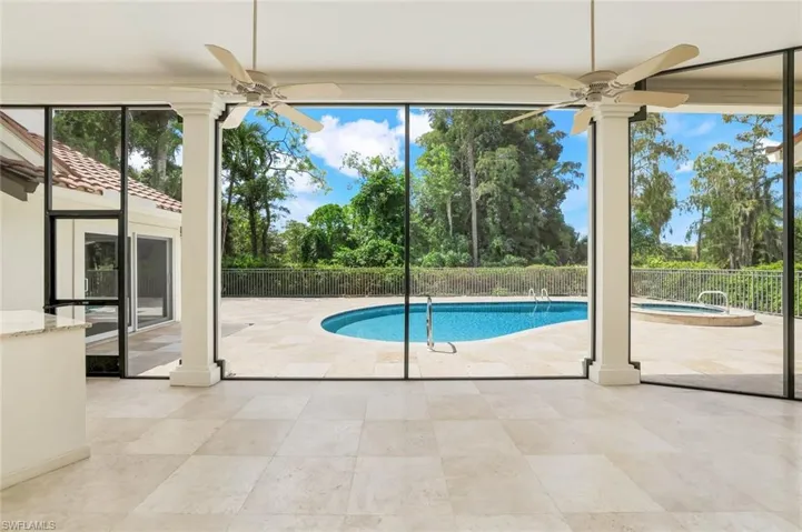 View of pool featuring a ceiling fan, a patio area, and an in-ground hot tub